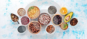 Healthy food. Superfoods Nuts, berries, fruits, and legumes. On a white stone background.