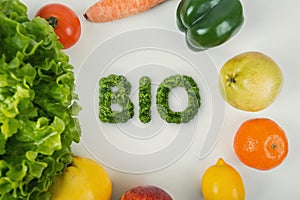 Healthy food on the table with Bio text in the middle. Organic fruits and vegetables from the farm garden. Bunch of fresh crop, photo