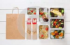 Healthy food take away in boxes, top view at wood