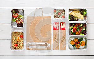 Healthy food take away in boxes, top view at wood