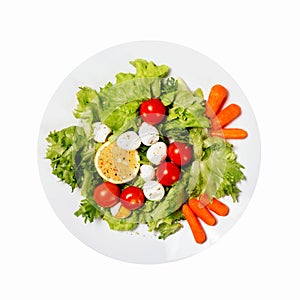 Healthy food. Tasty salad with cherry tomatoes, salad leaves, lemon, spices, carrot and quail eggs isolated on white background