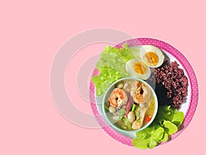 Healthy food Thai shrimp spicy sour soup with riceberry, fresh vegetable and boiled egg. Spicy  ingredient with chili cooking.