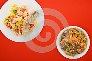 Healthy food. Vegetarian slates on a white plate. salad of crab, cucumber, corn, tomato and lettuce on a colored background