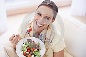 Healthy food, woman in portrait with salad and diet, organic vegetables and relax on sofa with smile for weight loss