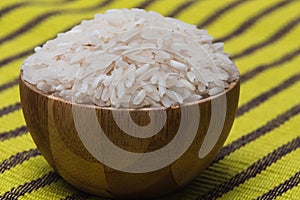 Healthy food. Wooden bowl with parboiled rice.