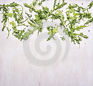 Healthy foods, cooking and vegetarian concept arugula salad on wooden rustic background top view close up place text