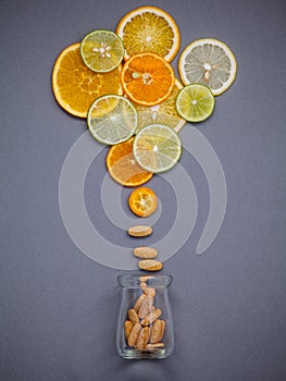 Healthy foods and medicine concept. Bottle of vitamin C and various citrus fruits. Citrus fruits sliced lime,orange and lemon on