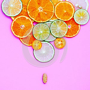 Healthy foods and medicine concept. Pill of vitamin C and various citrus fruits. Citrus fruits sliced lime,orange ,kumquat and le