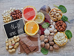 Healthy foods to boost nitric oxide levels with chemical formula of nitric oxide. Fruit, vegetable and nuts high in nitrates. photo