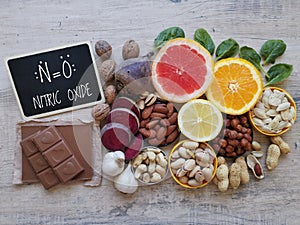 Healthy foods to boost nitric oxide levels with chemical formula of nitric oxide. Fruit, vegetable and nuts high in nitrates.