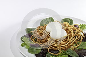 Healthy free range hen`s egg salad with spiralized potato nest photo