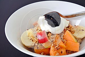 Healthy fresh fruit cereal and Greek yogurt served in a bowl for breakfast