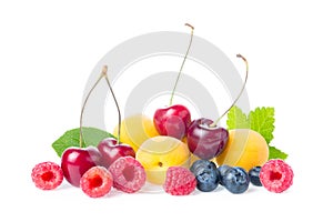 Healthy fresh fruits. Composition of ripe red sweet cherry with horns, raspberries, apricots and blueberries with leaves isolated