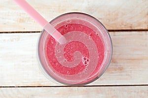 Healthy fresh smoothie drink from raspberries and coconat in glass with straw