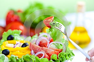 Healthy fresh vegetable salad and olive oil