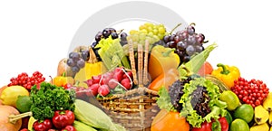 Healthy fresh vegetables and fruits in willow basket isolated on white.