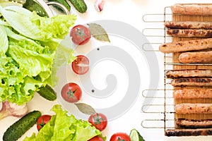 Healthy fresh vegetables for salad and roasted sausages on grill. Raw green lettuce, greens, tomato. Top view. Copy space. Food co