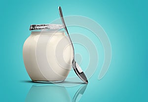 Healthy fresh yogurt with spoon on background