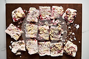 Healthy Frozen Greek Yogurt bars with strawberry with lime zest, nuts and white chocolate. Homemade sweet dessert