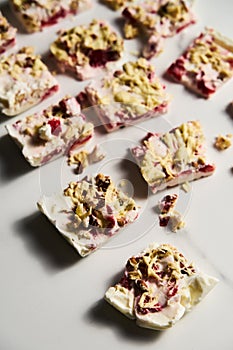 Healthy Frozen Greek Yogurt bars with strawberry with lime zest, nuts and white chocolate. Homemade sweet dessert on