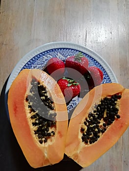 Healthy fruit breakfast of papaya and strawberries