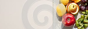 Healthy fruit platter, oranges ,apples ,kiwis, grapes ,pear on the white table, top view, copy space, selective focus