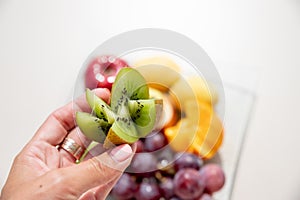 Healthy fruit platter, oranges ,apples ,kiwis, grapes ,pear on the white table, top view, copy space, selective focus