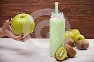 Healthy fruit smoothie on rustic wood table.