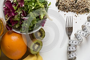 Healthy fruit,vegetables and measuring tape around the fork. Weight loss and right nutrition concept photo