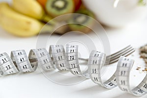 Healthy fruit,vegetables and measuring tape around the fork. Weight loss and right nutrition concept photo