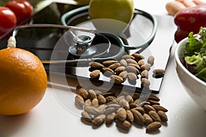 Healthy fruit,vegetables and stethoscope on scales. Weight loss and right nutrition concept photo