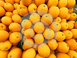 Healthy fruits, orange fruits background many orange fruits - orange fruit background in a supermarket super store