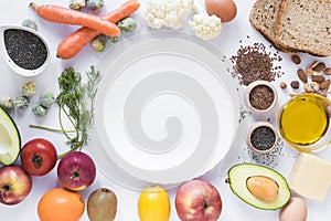 healthy fruits vegetables dryfruits bread seeds cheese egg oil with empty plate white background