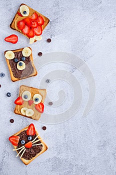 Healthy funny face sandwiches for kids. Animal faces toast with peanut and hazelnat chocolate butter