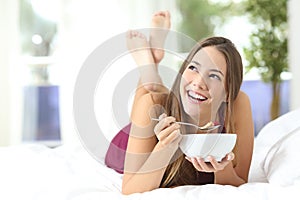 Healthy girl eating cereals at breakfast