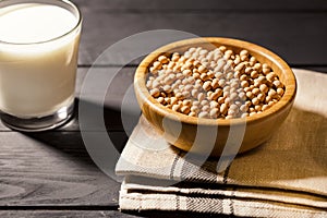Healthy glass of soymilk and soyseeds in a bowl