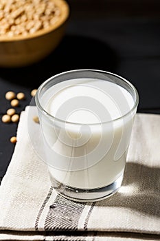 Healthy glass of soymilk and soyseeds in a bowl