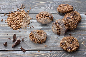 Healthy gluten-free buckwheat cookies with chocolate on wooden table