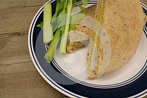 Healthy Gluten Free organic turkey sandwich with celery sticks.