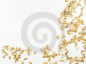 Healthy and golden yellow oat grain flake cereal placed on one corner of the image on a white background forming a frame of