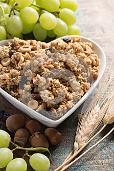 Healthy granola muesli breakfast with grape, nuts and wheat ears