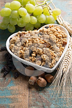 Healthy granola muesli breakfast with grape, nuts and wheat ears