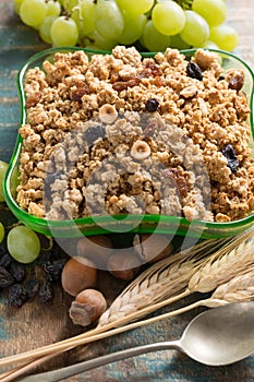 Healthy granola muesli breakfast with grape, nuts and wheat ears