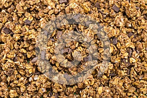 Healthy granola muesli cereals with chocolate background