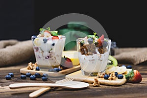 Healthy Greek yogurt with Granola and mixed berries on wooden ta