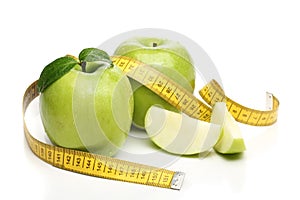 Healthy green apple and a measuring tape