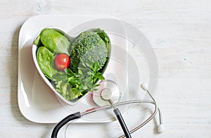Healthy green diet in the heart concept with stethoscope