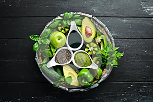 Healthy Green food Clean eating selection Protein source for vegetarians: avocado, lime, onion, apple, kiwi, spirulina. photo