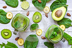 healthy green smoothie with avocado, banana, spinach, mint, almonds and chia seeds