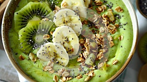 Healthy green smoothie bowl with kiwi and banana toppings